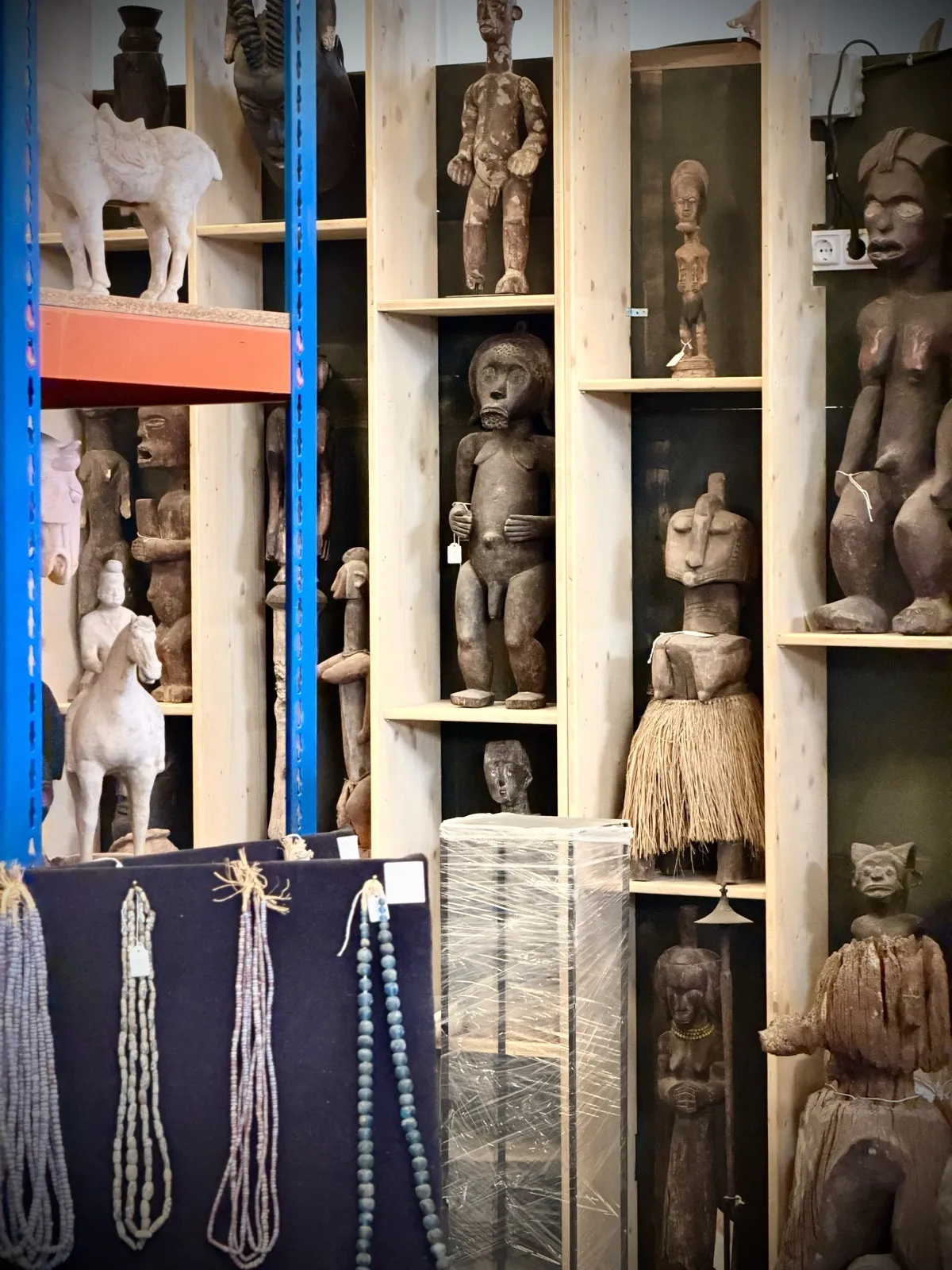 African figures with beadwork and a Chinese horse