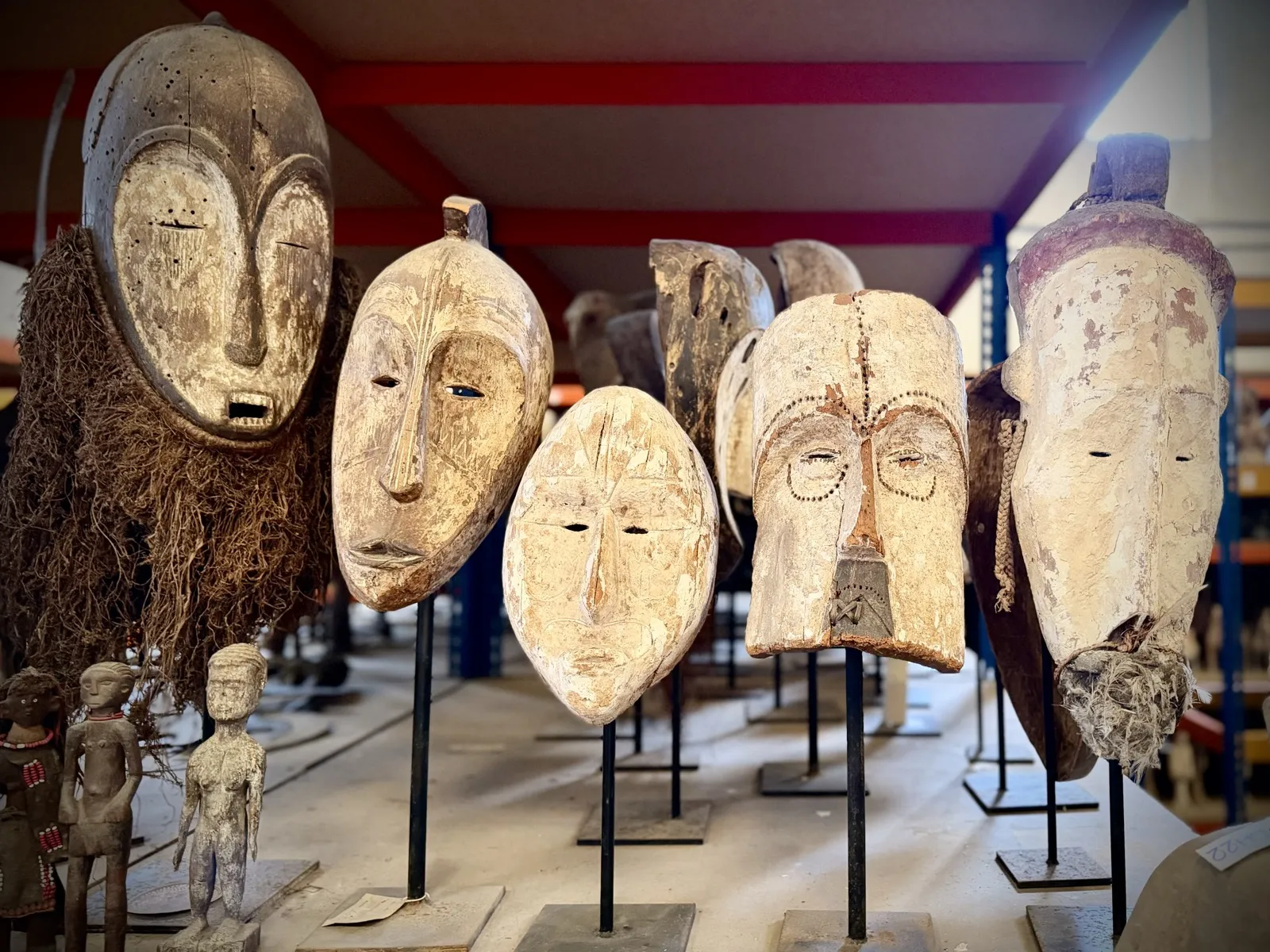 White ancestral masks of West and Central Africa on stands