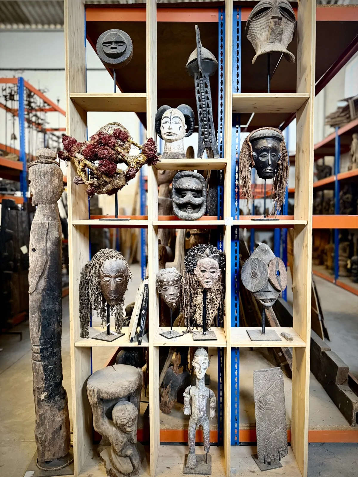 Shelf of African figures, masks and a reliquary guardian